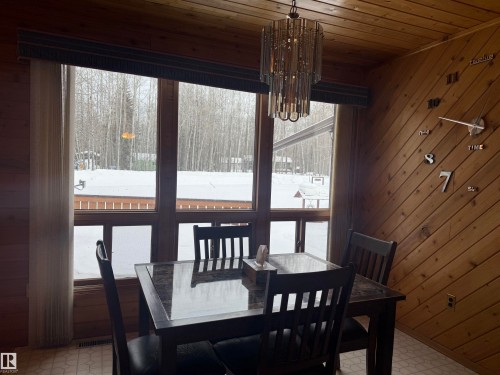 Dining room with light floors, plenty of natural light, wooden walls, a chandelier, and wooden ceiling - 34 Ella Mae Crescent, Athabasca Town, AB - Indoor Photo Showing Dining Room
