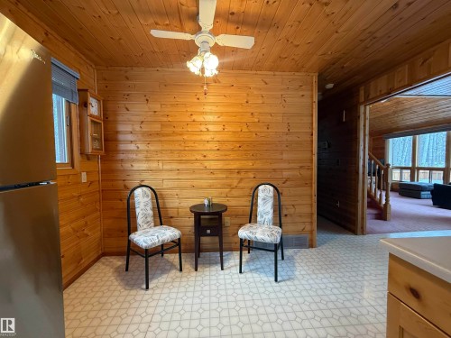 Living area featuring wood walls, stairway, and wood ceiling - 34 Ella Mae Crescent, Athabasca Town, AB - Indoor Photo Showing Other Room