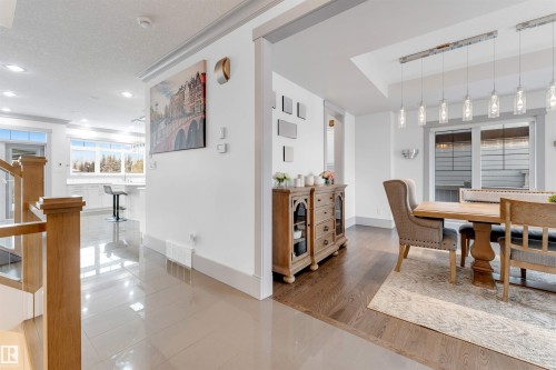 Dining space featuring tile patterned floors, a textured ceiling, recessed lighting, and stairs - 656 180 Street, Edmonton, AB - Indoor Photo Showing Dining Room