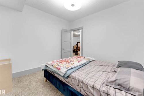 Bedroom with carpet and a textured ceiling - 656 180 Street, Edmonton, AB - Indoor Photo Showing Bedroom