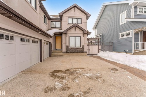 Traditional home with stucco siding, stone siding, driveway, and a garage - 656 180 Street, Edmonton, AB - Outdoor