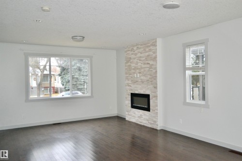8950 81 Avenue, Edmonton, AB - Indoor Photo Showing Living Room With Fireplace