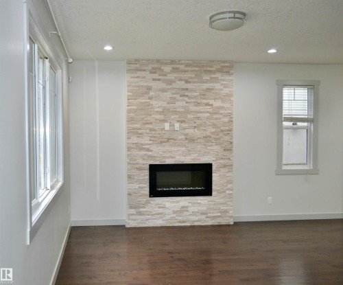 8950 81 Avenue, Edmonton, AB - Indoor Photo Showing Living Room With Fireplace
