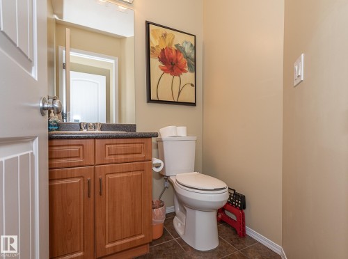 Half bath with vanity and dark tile patterned flooring - 20628 49 Avenue, Edmonton, AB - Indoor Photo Showing Bathroom