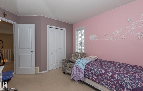 Bedroom with a closet, carpet, and a textured ceiling - 20628 49 Avenue, Edmonton, AB - Indoor Photo Showing Bedroom