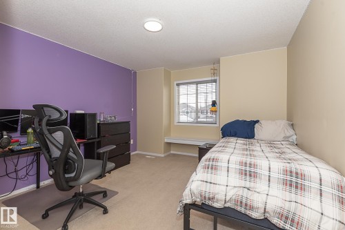 Bedroom featuring light colored carpet, a desk, and a textured ceiling - 20628 49 Avenue, Edmonton, AB - Indoor Photo Showing Bedroom