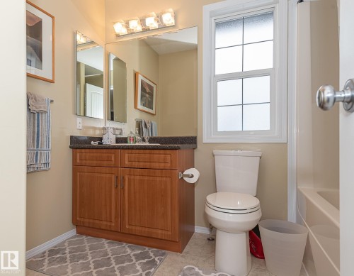 Bathroom with vanity, light tile patterned floors, and shower / washtub combination - 20628 49 Avenue, Edmonton, AB - Indoor Photo Showing Bathroom