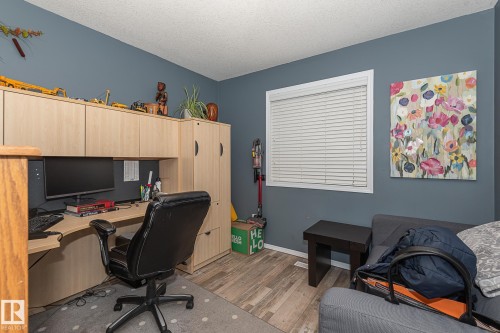 Office area with dark wood-style floors and a textured ceiling - 20628 49 Avenue, Edmonton, AB - Indoor Photo Showing Other Room