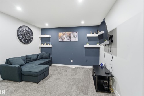 Living area featuring light carpet and recessed lighting - 452 Roberts Crescent, Leduc, AB - Indoor