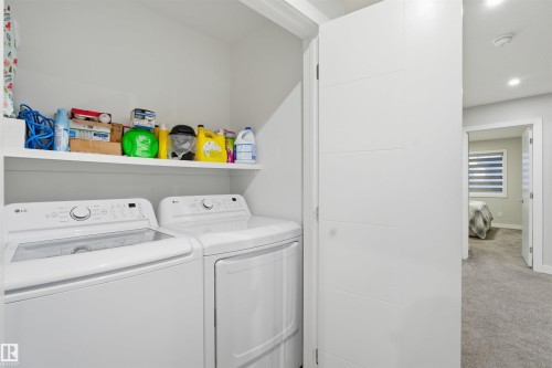 Laundry room with washer and dryer, carpet floors, and recessed lighting - 452 Roberts Crescent, Leduc, AB - Indoor Photo Showing Laundry Room