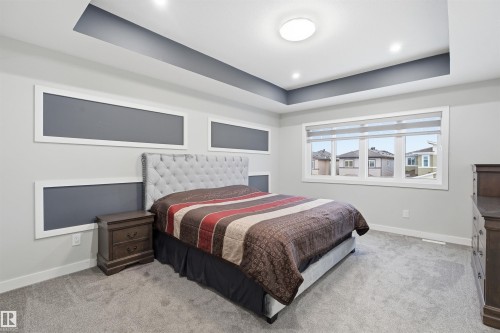 Bedroom with a raised ceiling and light carpet - 452 Roberts Crescent, Leduc, AB - Indoor Photo Showing Bedroom