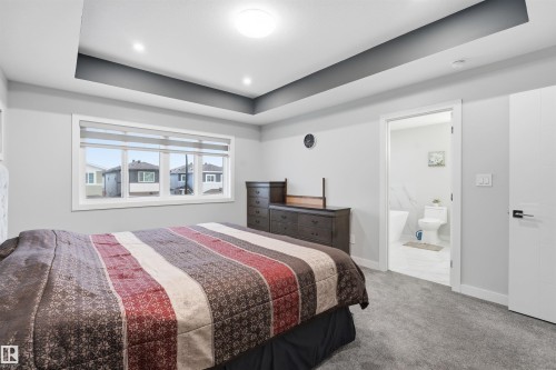Bedroom featuring a raised ceiling and carpet flooring - 452 Roberts Crescent, Leduc, AB - Indoor Photo Showing Bedroom