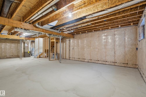 Unfinished basement with heating unit, water heater, and stairs - 452 Roberts Crescent, Leduc, AB - Indoor Photo Showing Basement