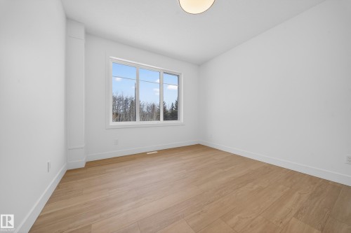 Empty room featuring light wood-type flooring and vaulted ceiling - 6115 Crawford Drive, Edmonton, AB - Indoor Photo Showing Other Room