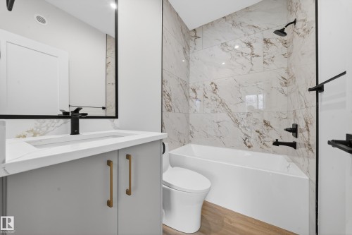 Full bathroom with tub / shower combination, vanity, and light wood-style flooring - 6115 Crawford Drive, Edmonton, AB - Indoor Photo Showing Bathroom