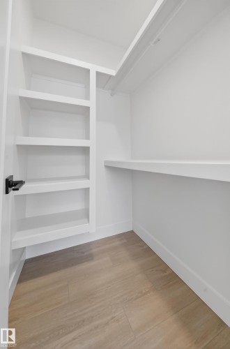 Walk in closet with light wood-style floors - 6115 Crawford Drive, Edmonton, AB - Indoor With Storage