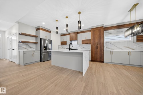 Kitchen featuring open shelves, an island with sink, light stone countertops, light wood-type flooring, and decorative backsplash - 6115 Crawford Drive, Edmonton, AB - Indoor Photo Showing Kitchen