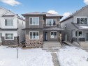 View of front of house with a balcony and stone siding - 6115 Crawford Drive, Edmonton, AB  - Outdoor With Facade 