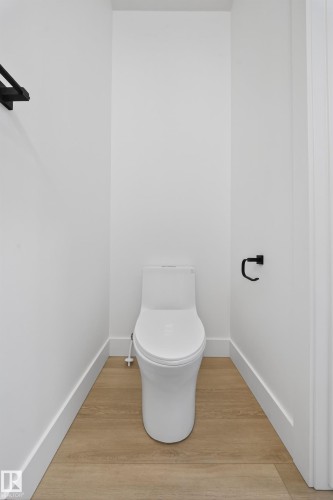 Bathroom with light wood-type flooring and toilet - 6115 Crawford Drive, Edmonton, AB - Indoor Photo Showing Bathroom