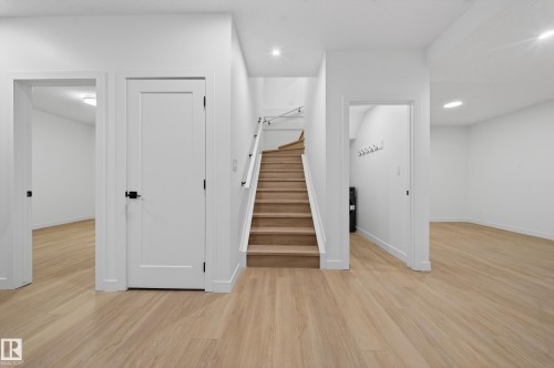 Stairs featuring wood finished floors and recessed lighting - 6115 Crawford Drive, Edmonton, AB - Indoor Photo Showing Other Room