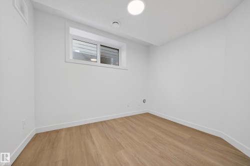 Spare room featuring baseboards and light wood-style flooring - 6115 Crawford Drive, Edmonton, AB - Indoor Photo Showing Other Room