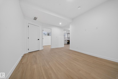 Empty room with light wood-style floors and recessed lighting - 6115 Crawford Drive, Edmonton, AB - Indoor Photo Showing Other Room