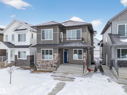 View of front of property with a balcony and stone siding - 6115 Crawford Drive, Edmonton, AB - Outdoor With Facade