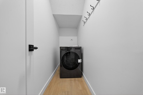 Laundry room with washer / clothes dryer and wood finished floors - 6115 Crawford Drive, Edmonton, AB - Indoor Photo Showing Laundry Room