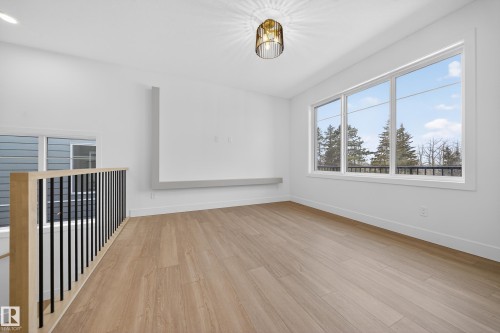 Unfurnished room with light wood-type flooring and baseboards - 6115 Crawford Drive, Edmonton, AB - Indoor Photo Showing Other Room