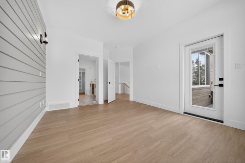 Spare room with light wood-style flooring and baseboards - 6115 Crawford Drive, Edmonton, AB - Indoor Photo Showing Other Room