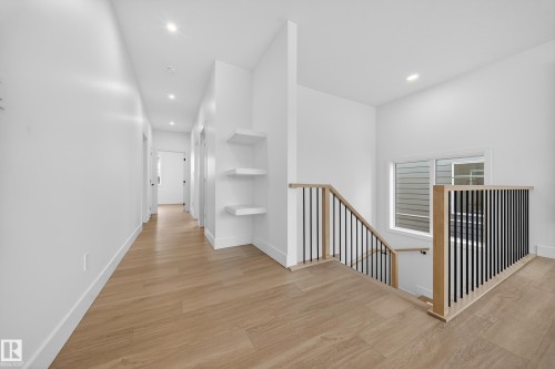 Hall with an upstairs landing, light wood-style flooring, and recessed lighting - 6115 Crawford Drive, Edmonton, AB - Indoor Photo Showing Other Room
