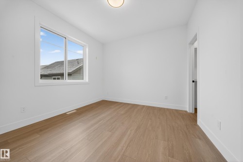 Spare room with light wood finished floors and baseboards - 6115 Crawford Drive, Edmonton, AB - Indoor Photo Showing Other Room
