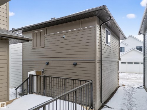 View of snow covered exterior with a garage - 6115 Crawford Drive, Edmonton, AB - Outdoor With Exterior