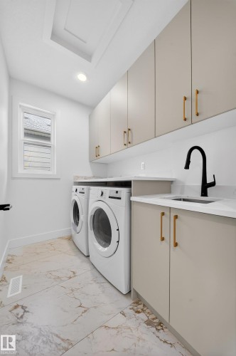 Washroom with cabinet space, light marble finish floors, separate washer and dryer, and recessed lighting - 6115 Crawford Drive, Edmonton, AB - Indoor Photo Showing Laundry Room