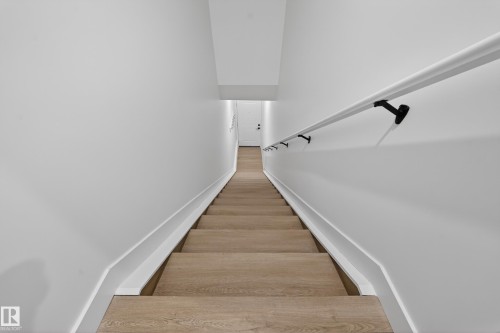 Stairway featuring wood finished floors and baseboards - 6115 Crawford Drive, Edmonton, AB - Indoor Photo Showing Other Room