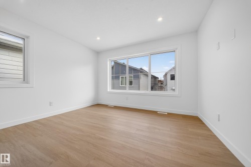 Spare room with light wood-style flooring and recessed lighting - 6115 Crawford Drive, Edmonton, AB - Indoor