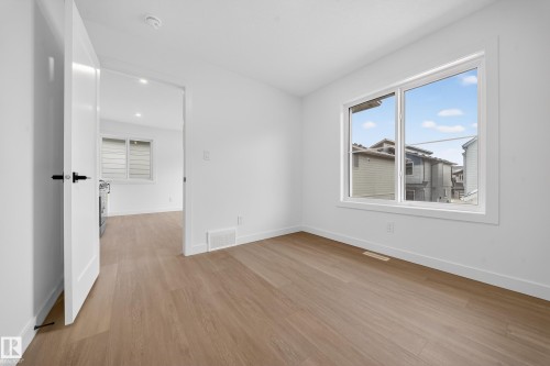 Spare room with baseboards and light wood finished floors - 6115 Crawford Drive, Edmonton, AB - Indoor Photo Showing Other Room