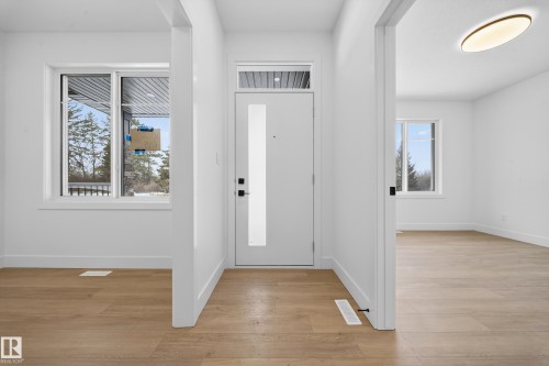 Entrance foyer featuring light wood-style flooring and healthy amount of natural light - 6115 Crawford Drive, Edmonton, AB - Indoor Photo Showing Other Room