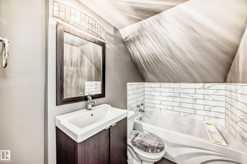 Full bathroom with vanity, vaulted ceiling, and shower / bathtub combination - 10115 104, Westlock, AB - Indoor Photo Showing Bathroom