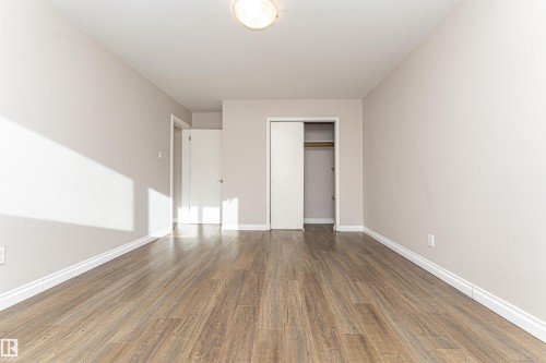 Unfurnished bedroom featuring wood finished floors and a closet - 102 10735 81 Avenue, Edmonton, AB - Indoor Photo Showing Other Room