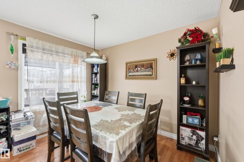 Dining space with wood finished floors and a textured ceiling - 3010 32 Avenue Nw, Edmonton, AB - Indoor Photo Showing Dining Room