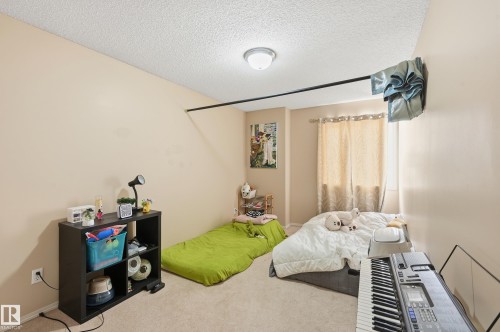 Bedroom featuring carpet flooring and a textured ceiling - 3010 32 Avenue Nw, Edmonton, AB - Indoor Photo Showing Other Room