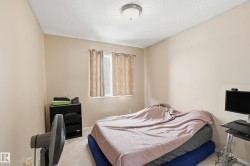 Bedroom with carpet and a textured ceiling - 