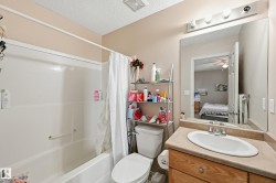 Full bathroom with vanity, shower / bathtub combination with curtain, a textured ceiling, ceiling fan, and connected bathroom - 