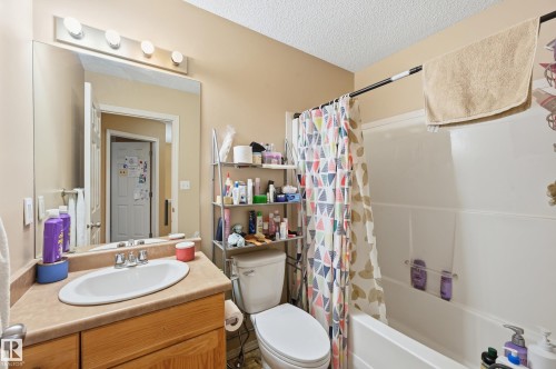 Bathroom featuring shower / tub combo with curtain, vanity, and a textured ceiling - 3010 32 Avenue Nw, Edmonton, AB - Indoor Photo Showing Bathroom