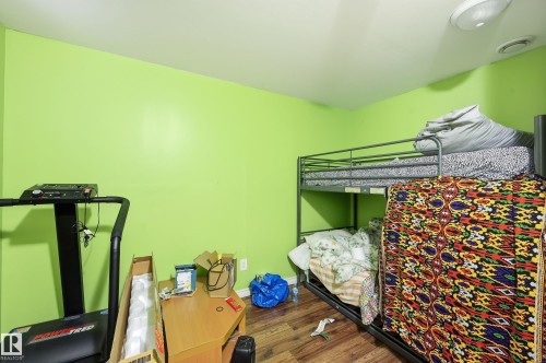 Bedroom with baseboards and dark wood-style floors - 3010 32 Avenue Nw, Edmonton, AB - Indoor