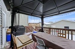 Deck featuring grilling area and outdoor dining space - 