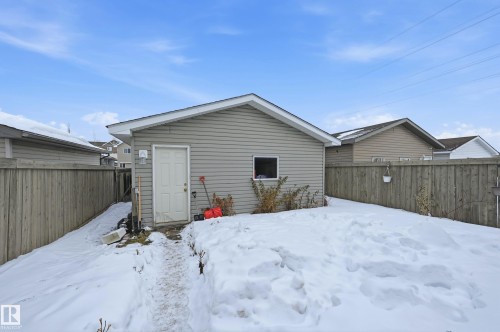 Snow covered rear of property featuring a fenced backyard - 3010 32 Avenue Nw, Edmonton, AB - Outdoor With Exterior