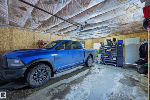 Garage with a garage door opener - 3010 32 Avenue Nw, Edmonton, AB - Indoor Photo Showing Garage