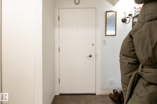 Doorway with baseboards and tile patterned floors - 307 5730 Riverbend Road, Edmonton, AB - Indoor Photo Showing Other Room